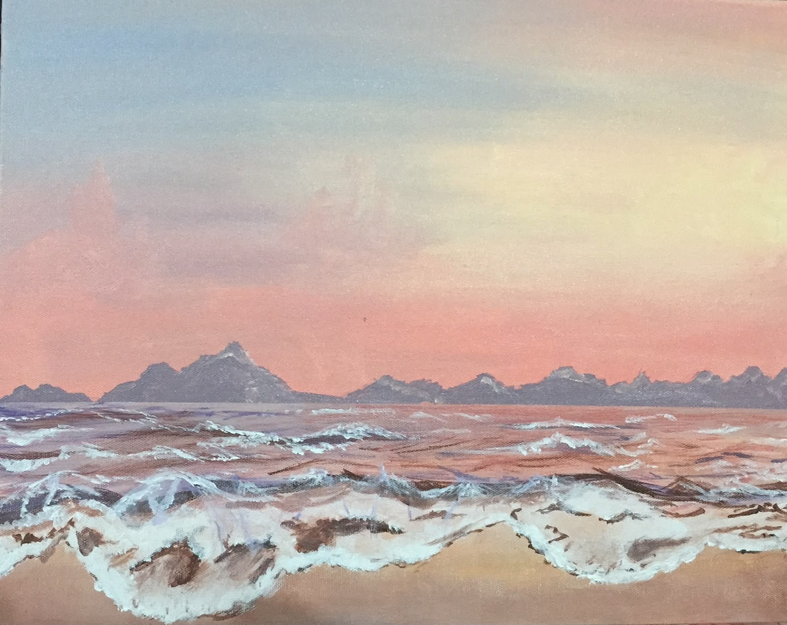 A calm sea at sunrise under a sky graded from soft blue through apricot to pale gold, with two ranks of breaking waves coming towards the viewer.